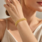 14K gold-plated bracelet in a wide woven mesh design